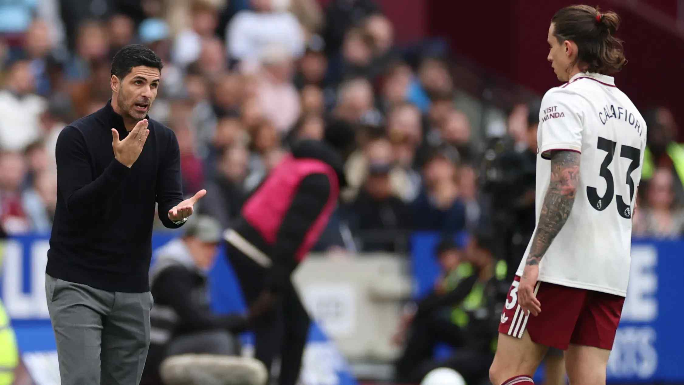 Arsenal's manager Mikel Arteta talking to Riccardo Calafiori